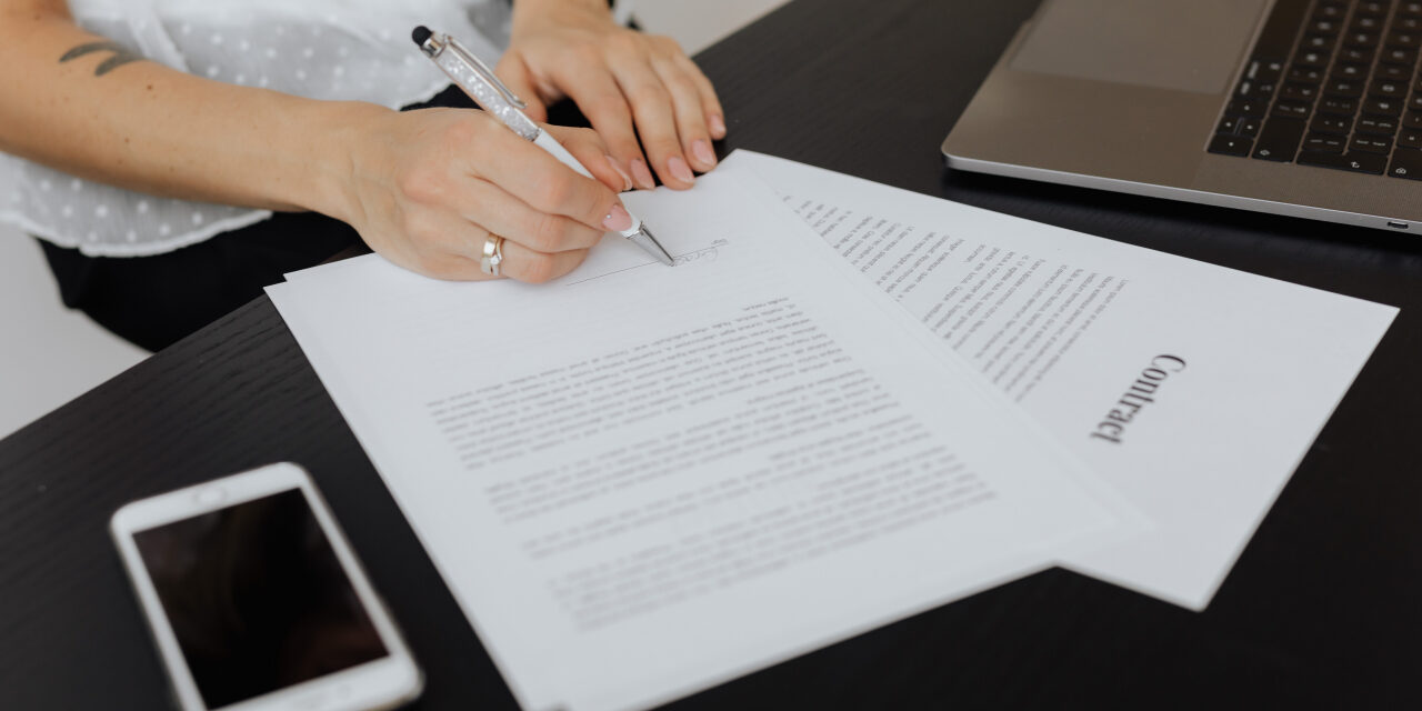 kaboompics_A businesswoman signs a contract